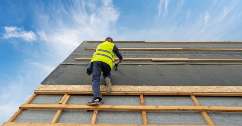 installation de sous toiture par un homme sur toit